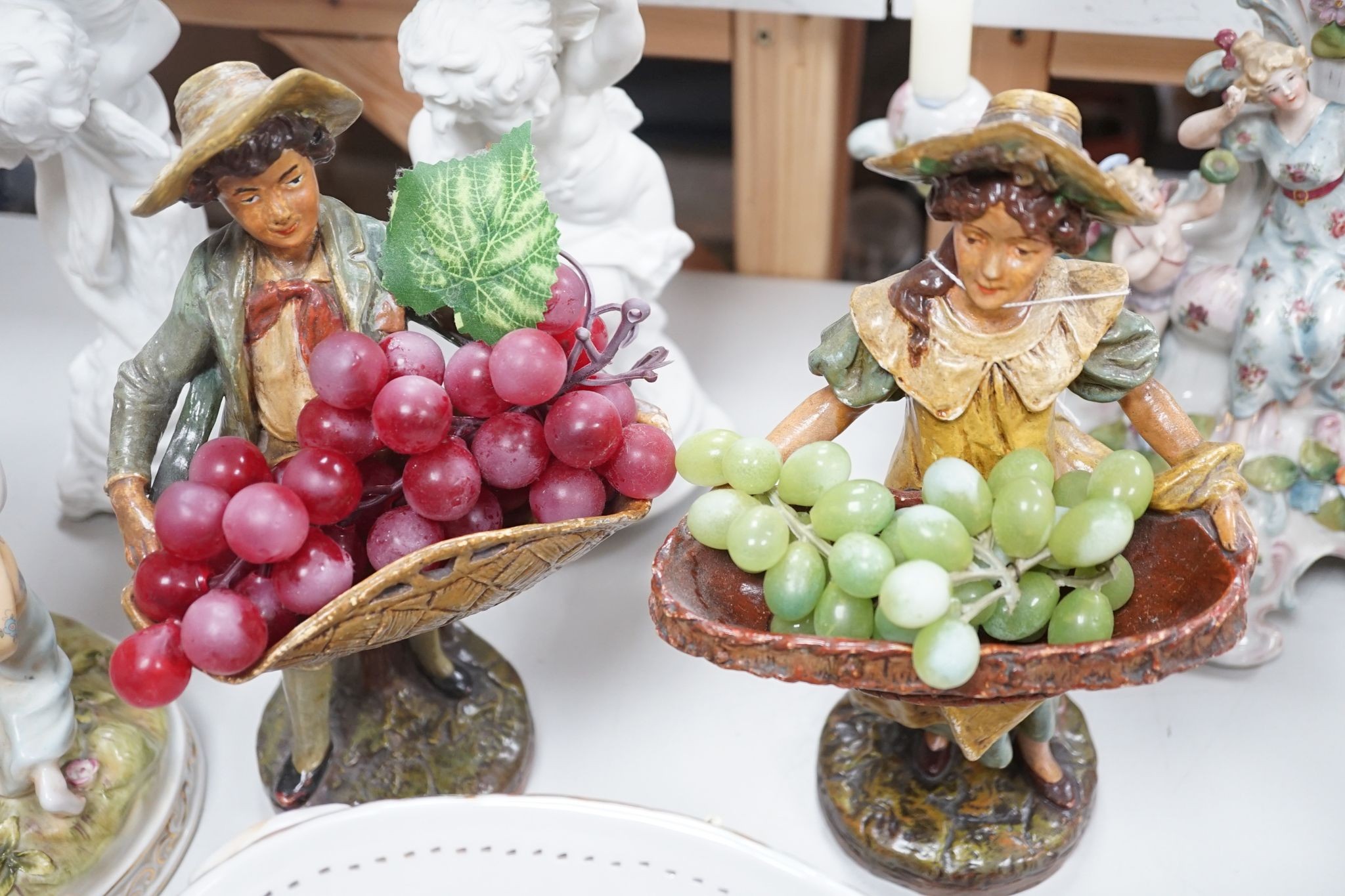 A group of Continental porcelain and pottery figural vases and centrepieces and two candelabra